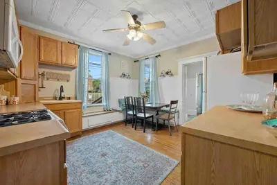 a kitchen with a table and a ceiling fan at The Village Townhouse - 5 BR in Columbus