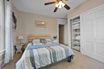 a bedroom with a bed and a ceiling fan at The Village Townhouse - 5 BR in Columbus