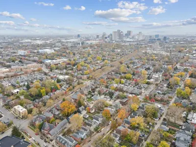 an aerial view of a city with fall foliage at The Village Townhouse - 5 BR in Columbus