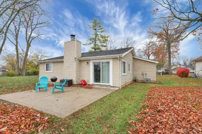 a small house with two blue chairs in the yard at The Spacious Hilliard House in Columbus