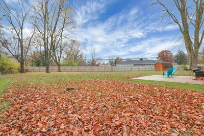 a pile of leaves in a park with a bench at The Spacious Hilliard House in Columbus