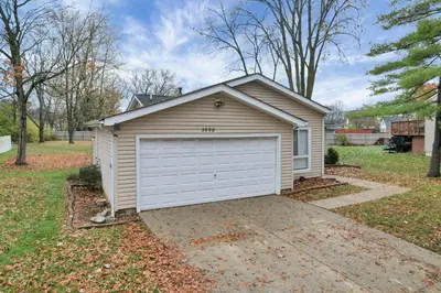 a garage with a white door in a yard at The Spacious Hilliard House in Columbus