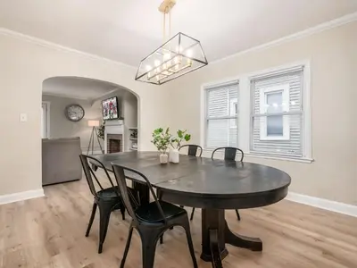 a dining room with a black table and chairs at Stay in the Palazzo in OSU! 10 BEDS! in Columbus