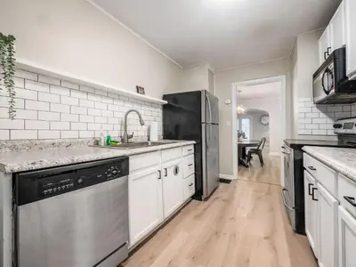 a kitchen with a sink and a dishwasher at Stay in the Palazzo in OSU! 10 BEDS! in Columbus