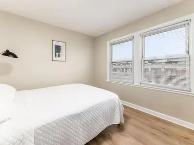 a bedroom with a white bed and two windows at Stay in the Palazzo in OSU! 10 BEDS! in Columbus