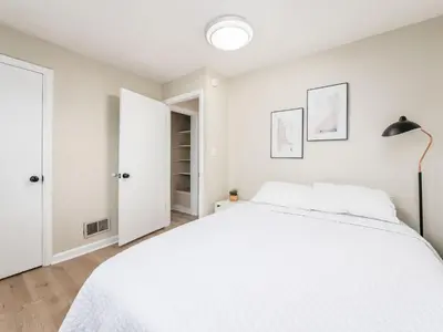 a bedroom with a white bed and a lamp at Stay in the Palazzo in OSU! 10 BEDS! in Columbus