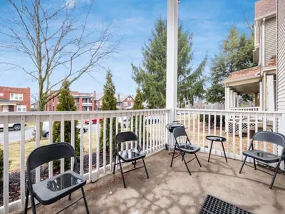 a porch with chairs and a white fence at Stay in the Palazzo in OSU! 10 BEDS! in Columbus
