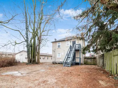 a house with a staircase in front of it at Stay in the Palazzo in OSU! 10 BEDS! in Columbus