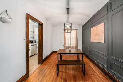 a dining room with a table and a mirror at The Cobblestone Townhouse - 2 BR -German Village in Columbus