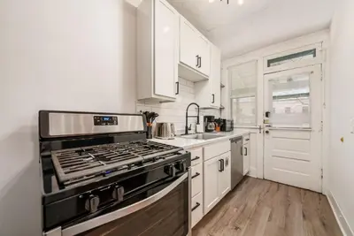 a kitchen with a stove and a sink at The Cobblestone Townhouse - 2 BR -German Village in Columbus