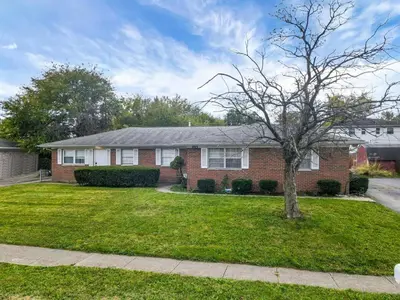 a brick house with a tree in the yard at Housepitality - The Gahanna Ranch - 3 BR - Airport in Gahanna