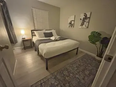 a bedroom with a bed and a table with a plant at Housepitality - The Gahanna Ranch - 3 BR - Airport in Gahanna