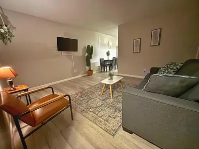 a living room with a couch and a table at Housepitality - The Gahanna Ranch - 3 BR - Airport in Gahanna
