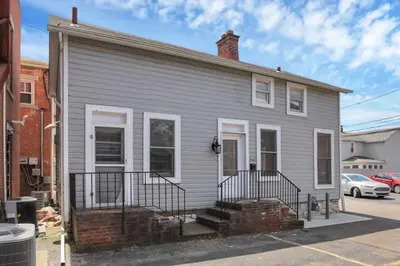 a gray house with a brick at Housepitality - The Marienplatz - Free Parking in Columbus