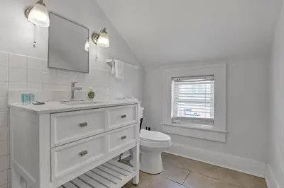 a white bathroom with a sink and a toilet at Housepitality - The Marienplatz - Free Parking in Columbus