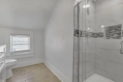 a white bathroom with a shower and a sink at Housepitality - The Marienplatz - Free Parking in Columbus