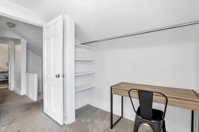 a room with a table and a chair and a closet at Housepitality - The Marienplatz - Free Parking in Columbus