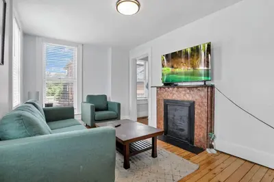 a living room with a couch and a fireplace at Housepitality - The Marienplatz - Free Parking in Columbus