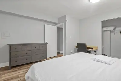 a bedroom with a bed and a desk and a dresser at German Village Hidden Gem - 3 BR, Parking l Value in Columbus