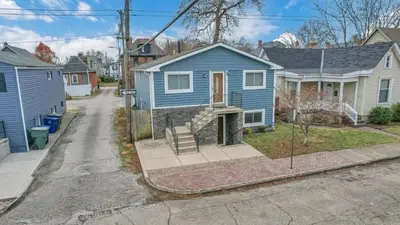 a blue house on a street in a residential neighborhood at German Village Hidden Gem - 3 BR, Parking l Value in Columbus