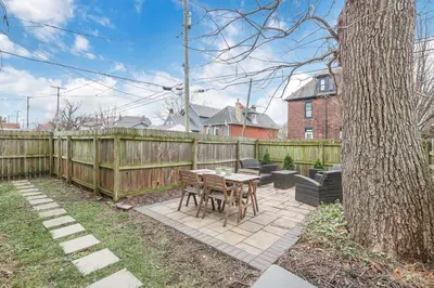 a patio with a table and chairs next to a fence at German Village Hidden Gem - 3 BR, Parking l Value in Columbus