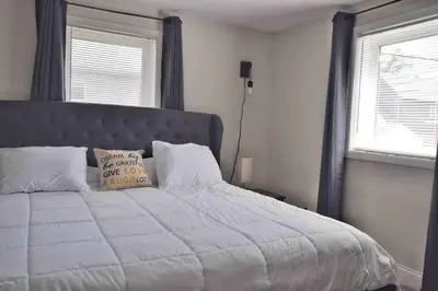a bedroom with a large bed with a pillow on it at Housepitality - Top Choice Flat - Location in Columbus