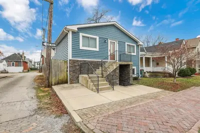 a blue house with a staircase in a street at Housepitality - Top Choice Flat - Location in Columbus