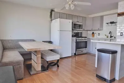 a kitchen with a table and a white refrigerator at Housepitality - Top Choice Flat - Location in Columbus