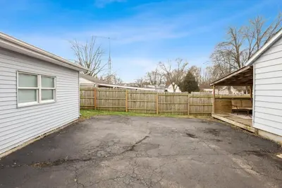 a driveway next to a house with a fence at Housepitality - Newark Friends and Family House in Newark