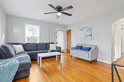 a living room with a couch and a ceiling fan at Housepitality - Newark Friends and Family House in Newark