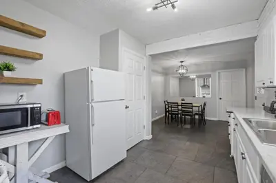 a kitchen with a white refrigerator and a table at Housepitality - Newark Friends and Family House in Newark