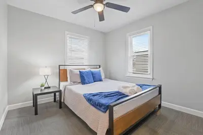 a bedroom with a bed and a ceiling fan at Housepitality - Newark Friends and Family House in Newark