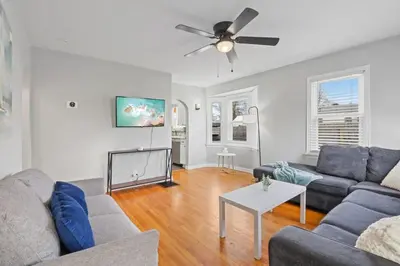 a living room with a couch and a ceiling fan at Housepitality - Newark Friends and Family House in Newark