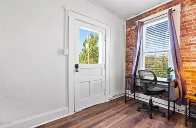 an empty room with a desk and a window at Housepitality - City View Loft - German Village in Columbus