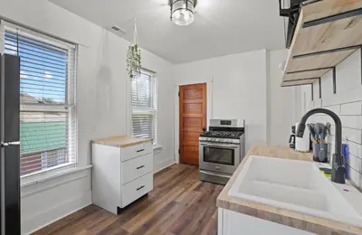 a kitchen with a sink and a stove at Housepitality - City View Loft - German Village in Columbus