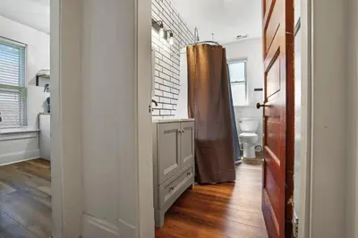 a bathroom with a shower and a toilet in it at Housepitality - Cityscape - Historic 2BR in Columbus