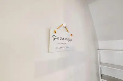 a sign hanging on a wall in a room at Housepitality - Cityscape - Historic 2BR in Columbus