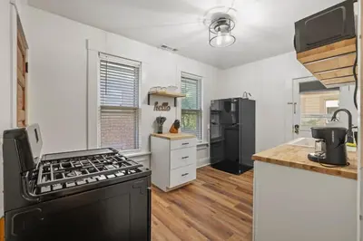 a kitchen with a stove and a refrigerator at Housepitality - Cityscape - Historic 2BR in Columbus
