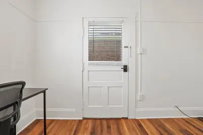 a white door with a window in a room at Housepitality - Cityscape - Historic 2BR in Columbus