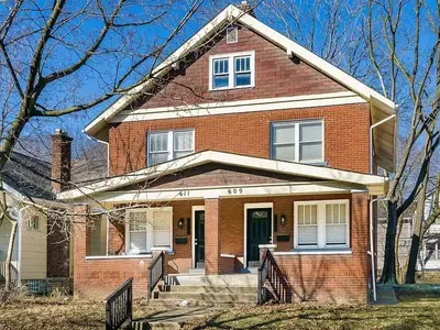 a red brick house with a porch and a door at Housepitality- The 614 Peaceful Escape - Old Town in Columbus