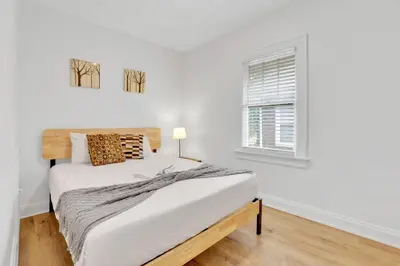 a white bedroom with a bed and a window at Housepitality- The 614 Peaceful Escape - Old Town in Columbus