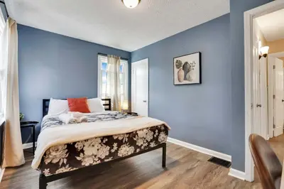 a bedroom with blue walls and a large bed at The Lucky 7's Inn-5 Beds in Columbus
