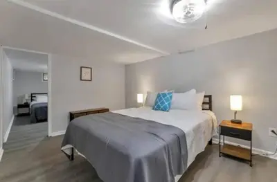 a bedroom with a large bed with blue pillows at The Lucky 7's Inn-5 Beds in Columbus