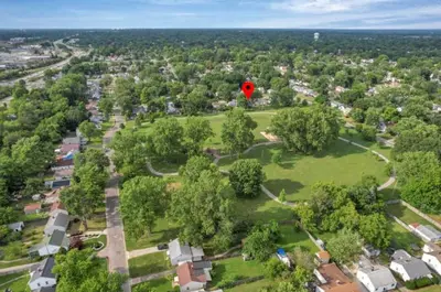 a red balloon flying over a park with trees at The Lucky 7's Inn-5 Beds in Columbus