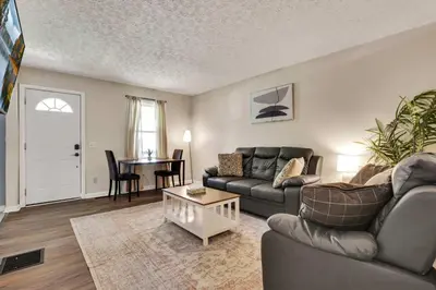 a living room with a couch and a table at The Lucky 7's Inn-5 Beds in Columbus