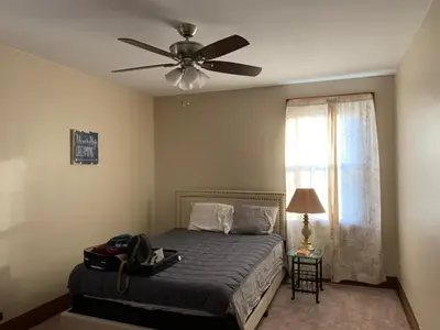 a bedroom with a bed and a ceiling fan at A2 Executive City View apartment perfect for traveling professionals in Norwood