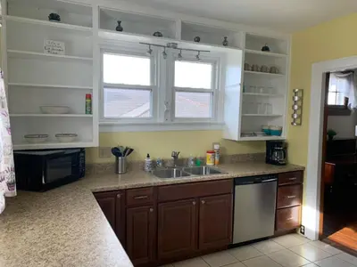a kitchen with a sink and two windows at A2 Executive City View apartment perfect for traveling professionals in Norwood