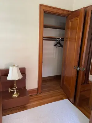 a room with a bed with a lamp and an open door at A2 Executive City View apartment perfect for traveling professionals in Norwood