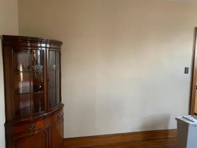 a wooden cabinet in a room with a white wall at A2 Executive City View apartment perfect for traveling professionals in Norwood