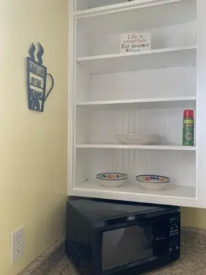 a microwave in a cabinet with two bowls on it at A2 Executive City View apartment perfect for traveling professionals in Norwood